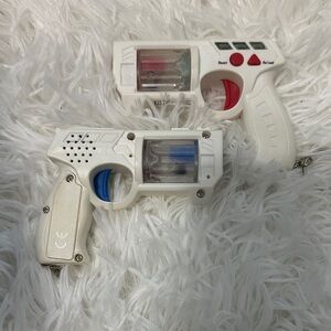 White Toy Laser Guns with Red and Blue Accents